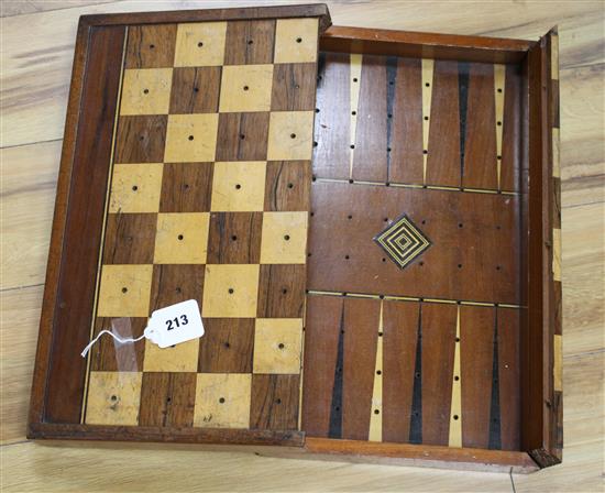 A Victorian mahogany folding games box, the interior marked for backgammon, the outer surface inlaid in rosewood and boxwood for